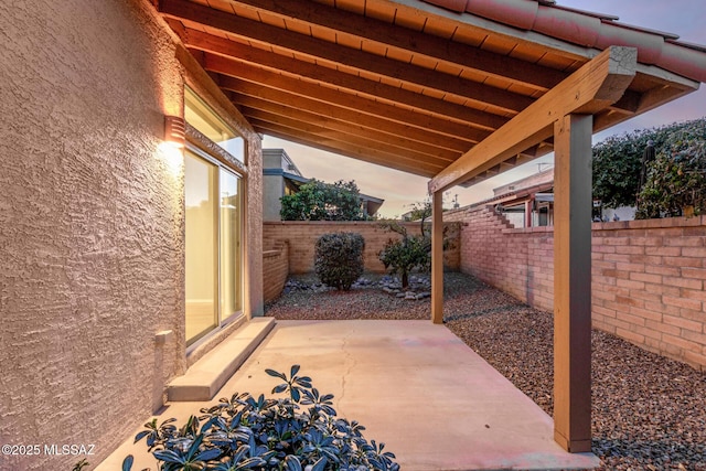 view of patio terrace at dusk