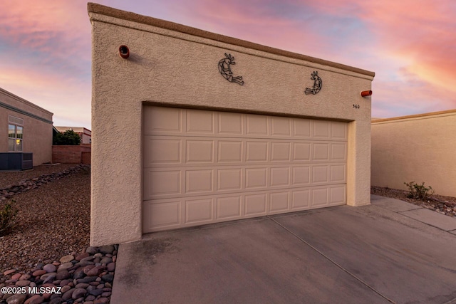 view of garage at dusk