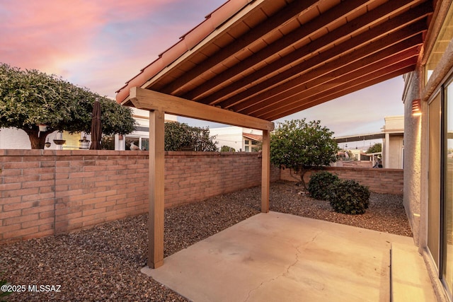 view of patio terrace at dusk