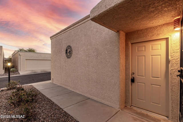 view of exterior entry at dusk