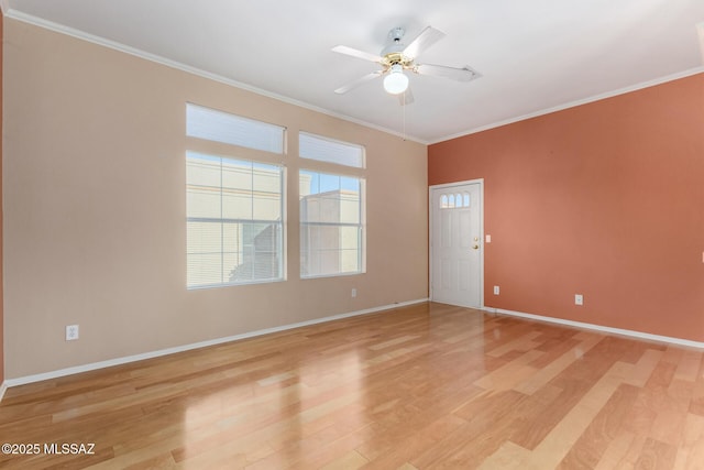 spare room featuring ceiling fan, ornamental molding, and light hardwood / wood-style flooring