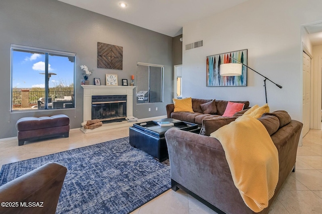 living room with high vaulted ceiling and tile patterned flooring