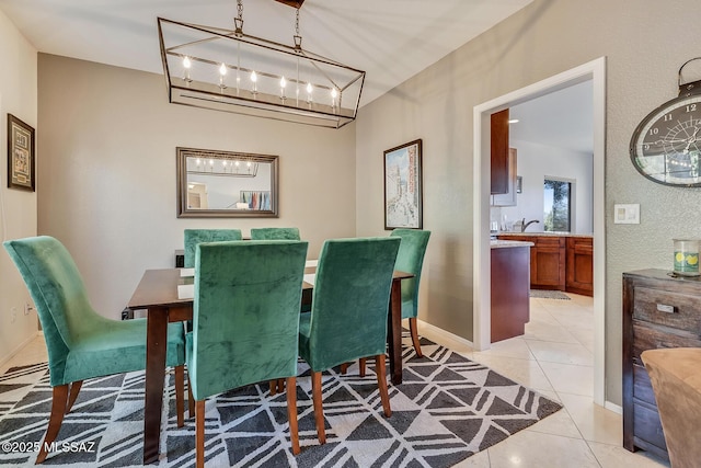 tiled dining area with sink and a notable chandelier
