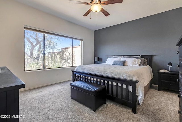 bedroom with ceiling fan and light carpet