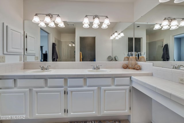 bathroom with a shower with door and vanity