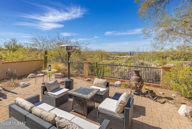 view of patio featuring an outdoor living space with a fire pit