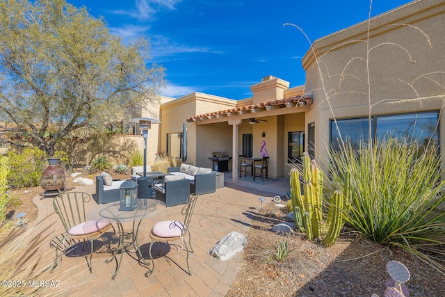 view of patio / terrace with ceiling fan, area for grilling, and an outdoor hangout area