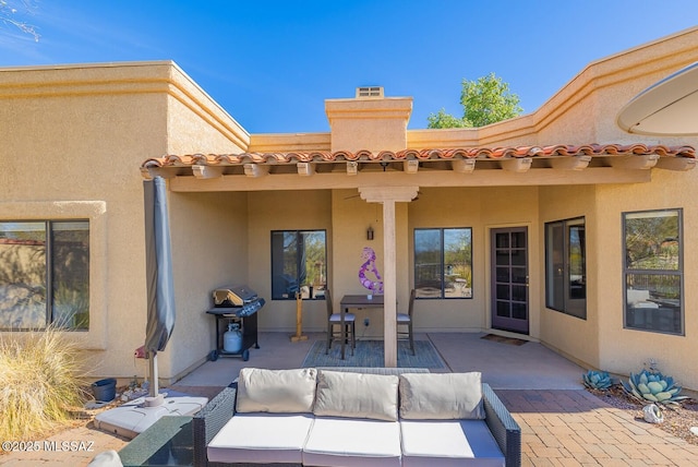 view of patio with area for grilling and an outdoor living space