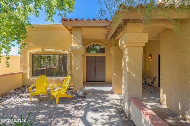 entrance to property featuring a patio