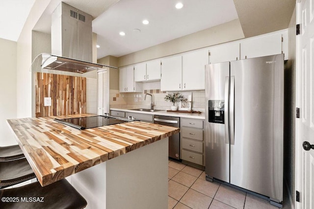 kitchen featuring sink, a breakfast bar, stainless steel appliances, white cabinets, and island exhaust hood