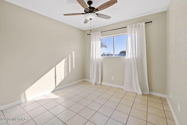 tiled empty room featuring ceiling fan