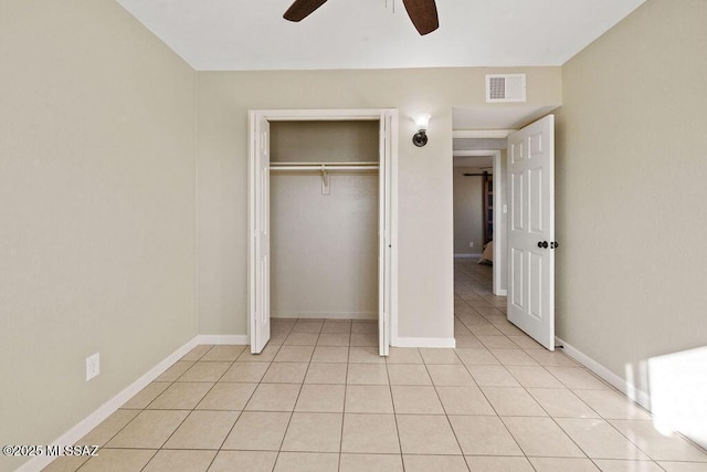 unfurnished bedroom with a closet, ceiling fan, and light tile patterned flooring