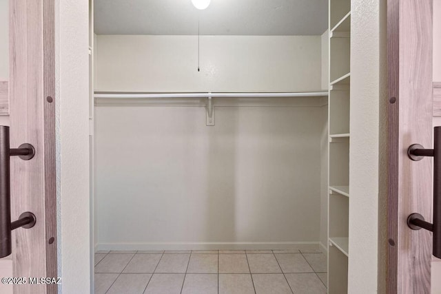 walk in closet featuring light tile patterned floors