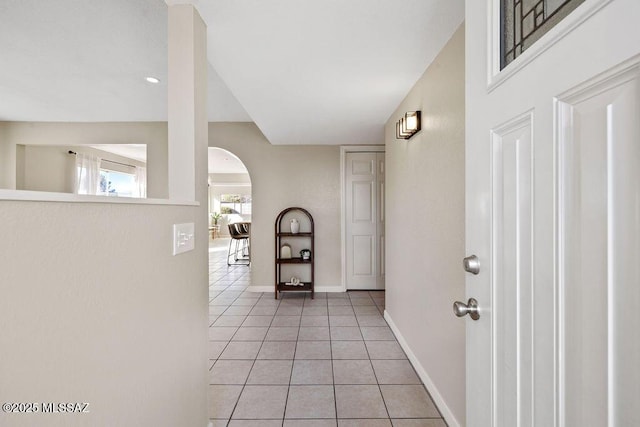 hall featuring light tile patterned floors