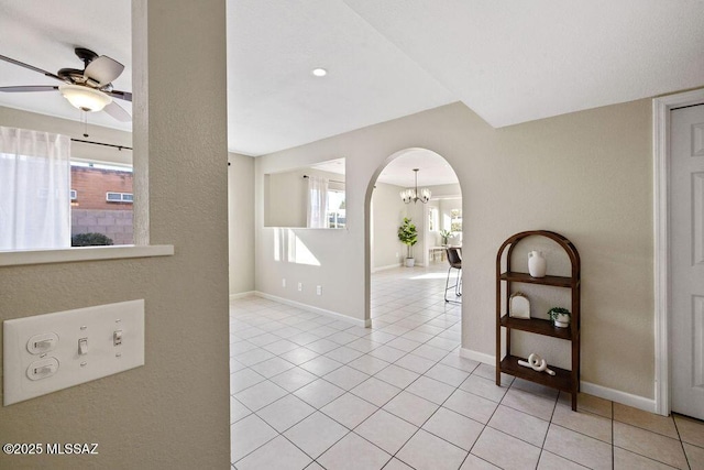 hallway featuring light tile patterned floors and a notable chandelier