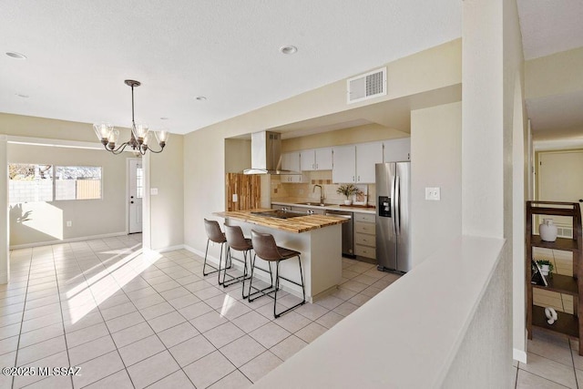 kitchen featuring extractor fan, light tile patterned flooring, sink, white cabinets, and stainless steel appliances