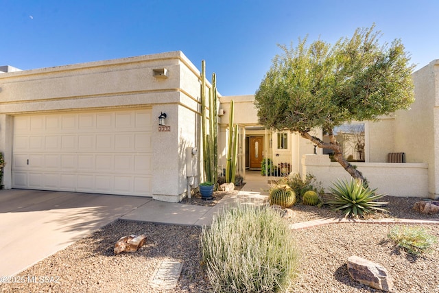 pueblo revival-style home with a garage