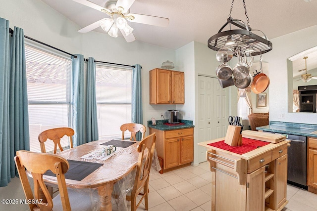 kitchen with ceiling fan, stainless steel dishwasher, pendant lighting, and light tile patterned floors