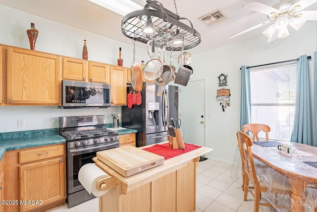 kitchen with light tile patterned flooring, ceiling fan, and appliances with stainless steel finishes