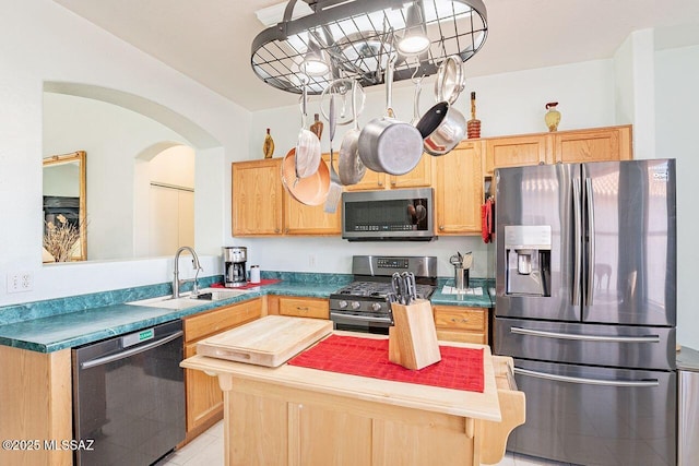 kitchen featuring light tile patterned flooring, appliances with stainless steel finishes, sink, and light brown cabinetry