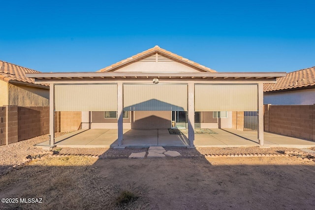 back of property with a patio