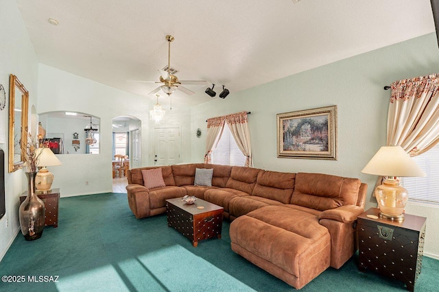 living room with vaulted ceiling, ceiling fan, and carpet floors