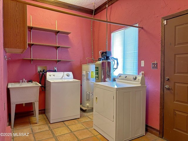 laundry room with crown molding, washing machine and clothes dryer, sink, and water heater