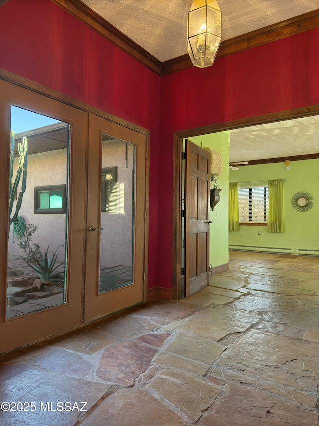 entrance foyer featuring crown molding, a textured ceiling, baseboard heating, and french doors