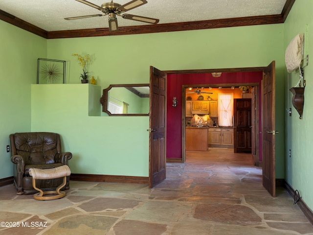 hall featuring ornamental molding and a textured ceiling