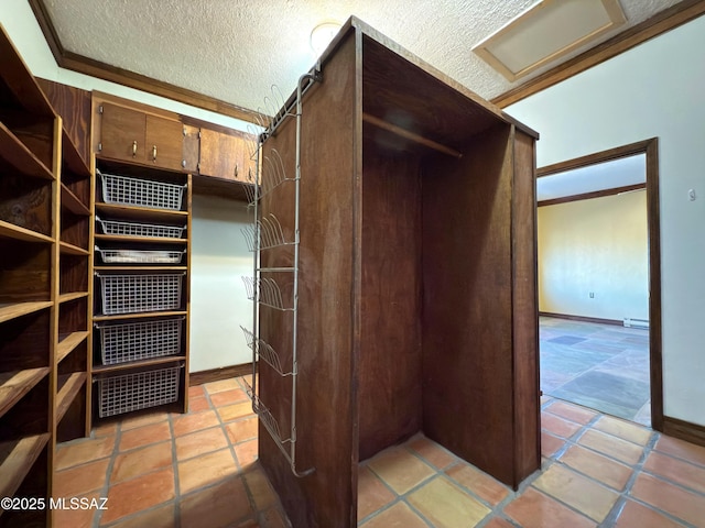 spacious closet with light tile patterned flooring and a baseboard heating unit