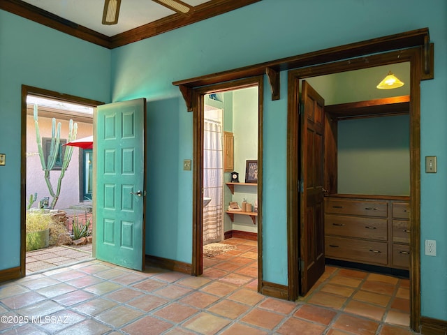 unfurnished bedroom with crown molding, connected bathroom, and light tile patterned floors