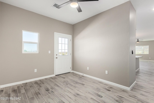 empty room featuring ceiling fan and light wood-type flooring