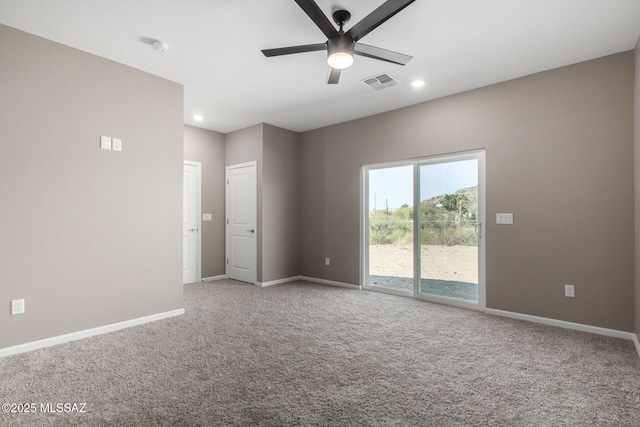 carpeted spare room featuring ceiling fan