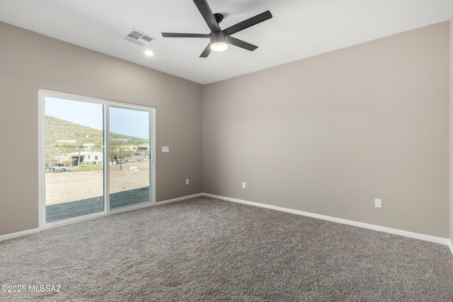 unfurnished room with ceiling fan and carpet flooring