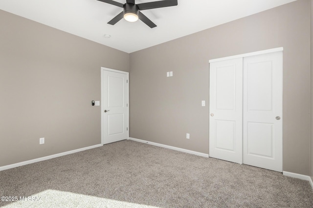 unfurnished bedroom with a closet, ceiling fan, and carpet