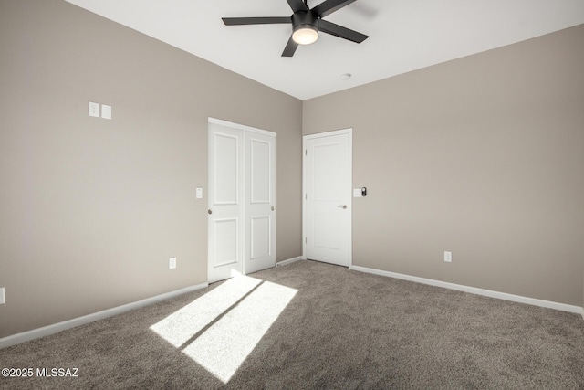 empty room featuring ceiling fan and carpet flooring