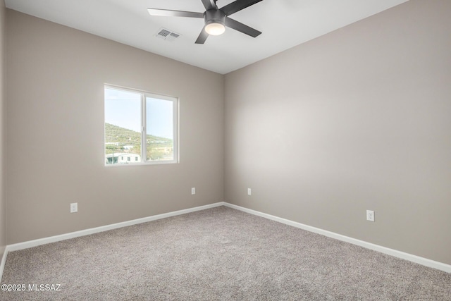 carpeted empty room featuring ceiling fan