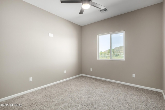 carpeted empty room featuring ceiling fan