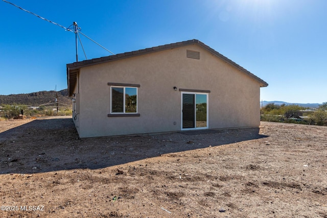 back of house with a mountain view