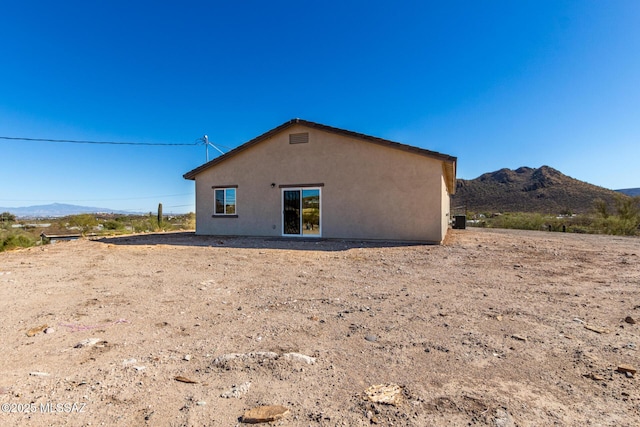 back of house featuring a mountain view