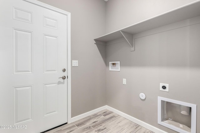 washroom featuring gas dryer hookup, hookup for an electric dryer, hookup for a washing machine, and light hardwood / wood-style flooring