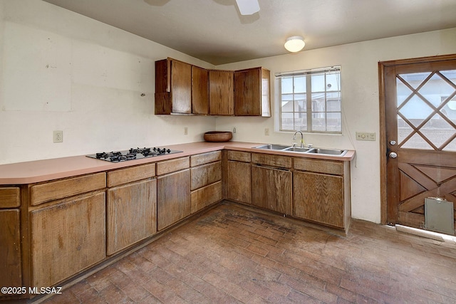 kitchen featuring sink, stainless steel gas stovetop, and ceiling fan