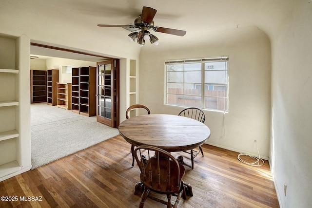 dining area with hardwood / wood-style floors and ceiling fan