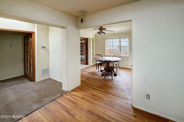 unfurnished dining area featuring hardwood / wood-style flooring and ceiling fan