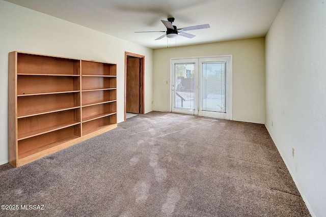 unfurnished living room with carpet and ceiling fan