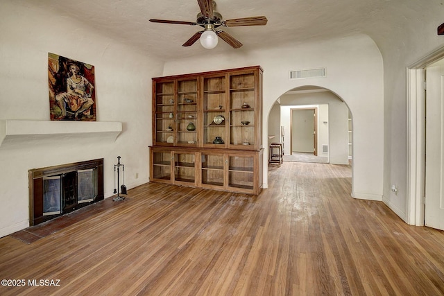 unfurnished living room featuring hardwood / wood-style floors and ceiling fan