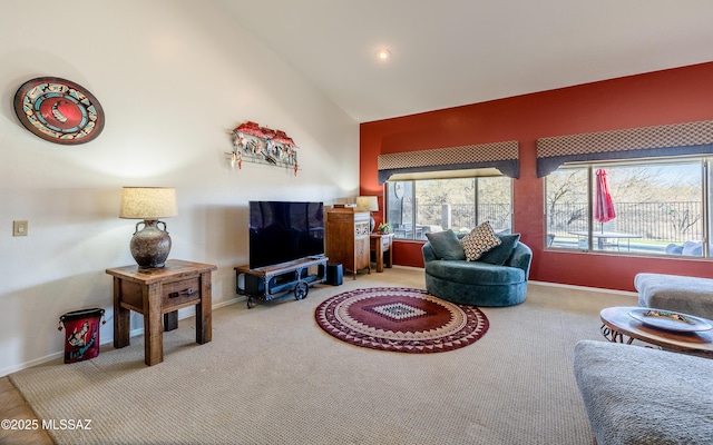 carpeted living room featuring high vaulted ceiling