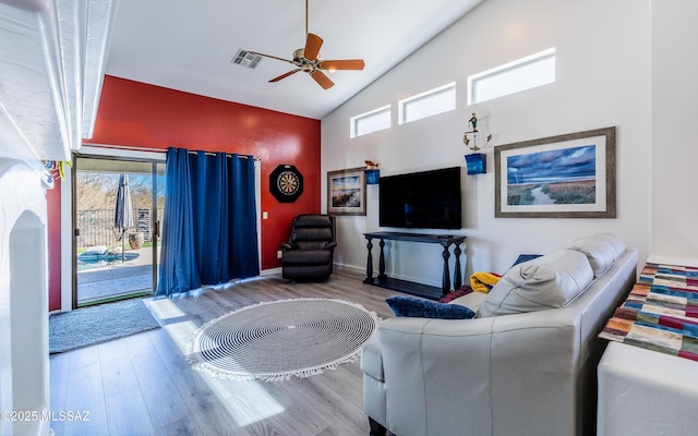 living room featuring ceiling fan, high vaulted ceiling, hardwood / wood-style floors, and a wealth of natural light