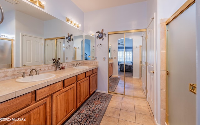 bathroom with tile patterned floors, vanity, and backsplash