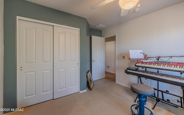 miscellaneous room featuring light colored carpet and ceiling fan